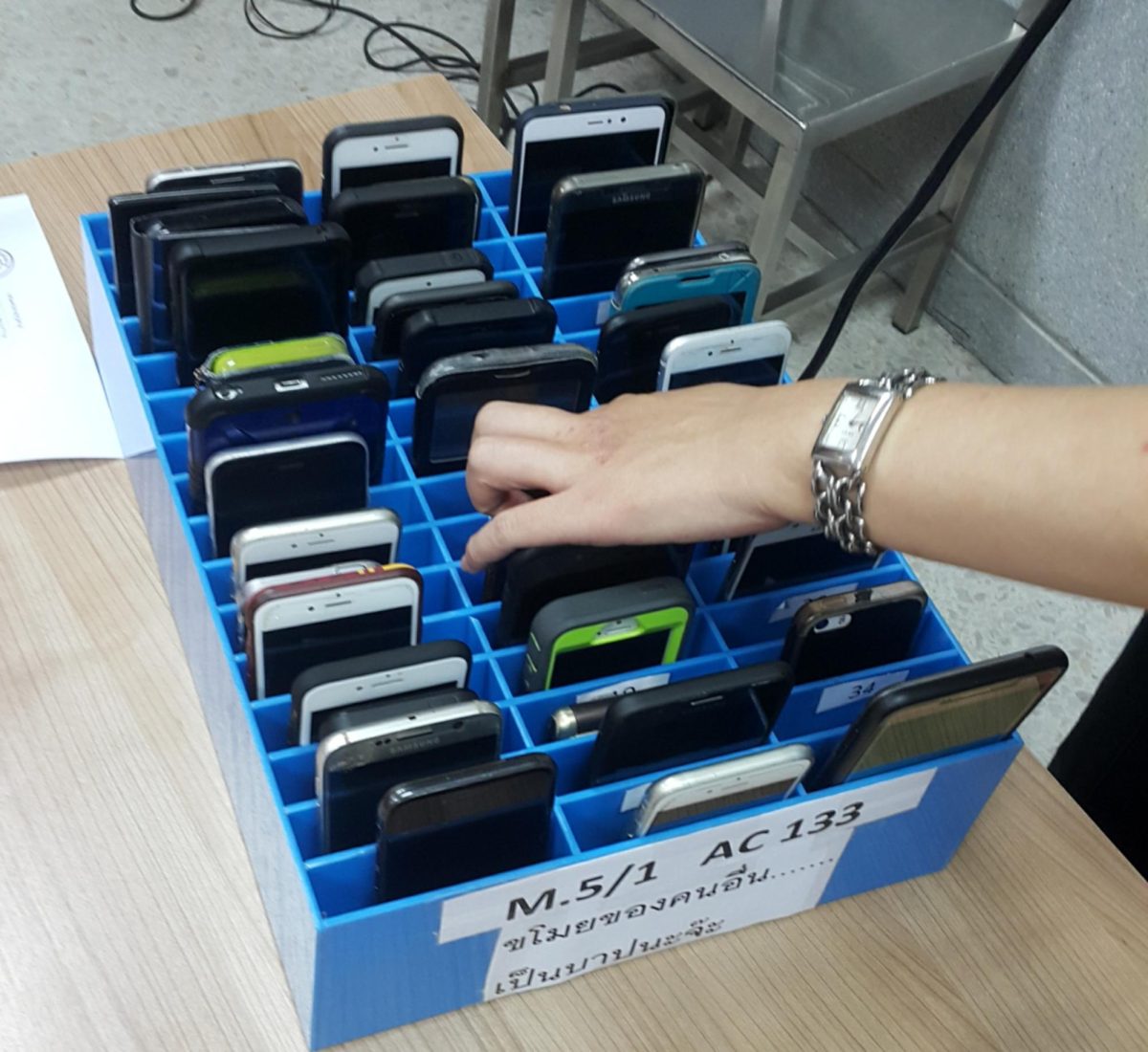 A mobile phone cage to prevent smartphone usage in classrooms.